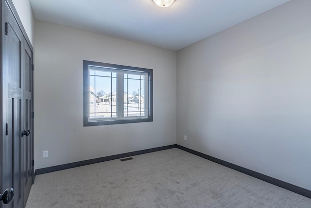 spare room with light colored carpet