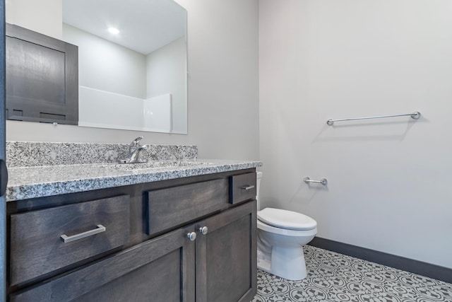 bathroom with vanity, tile patterned floors, and toilet