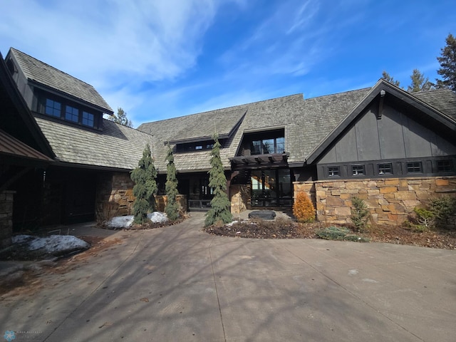 rear view of house with stone siding