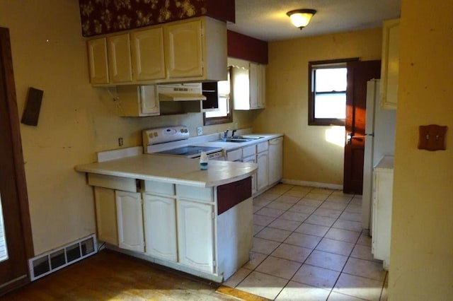 kitchen featuring white appliances and light tile patterned flooring