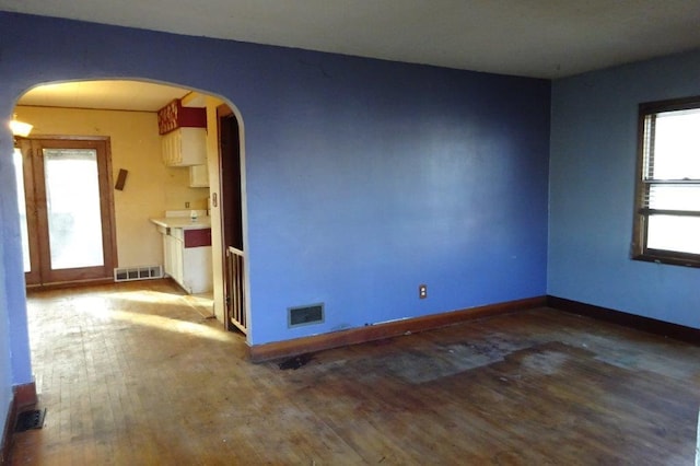 unfurnished room with wood-type flooring and plenty of natural light