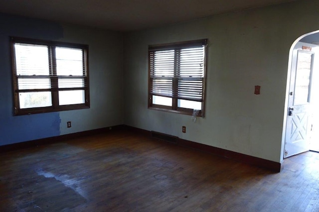 unfurnished room with dark hardwood / wood-style floors