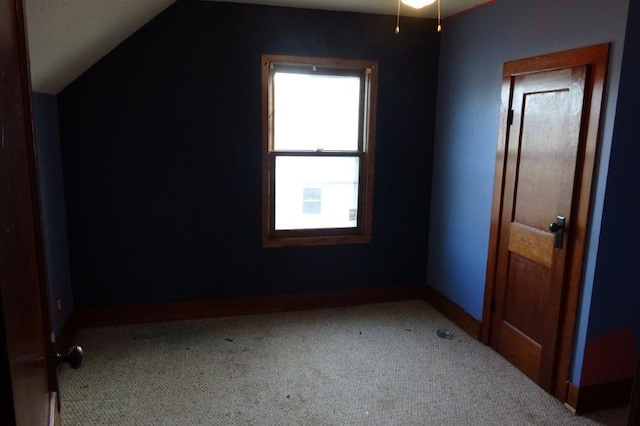 bonus room featuring lofted ceiling and carpet floors