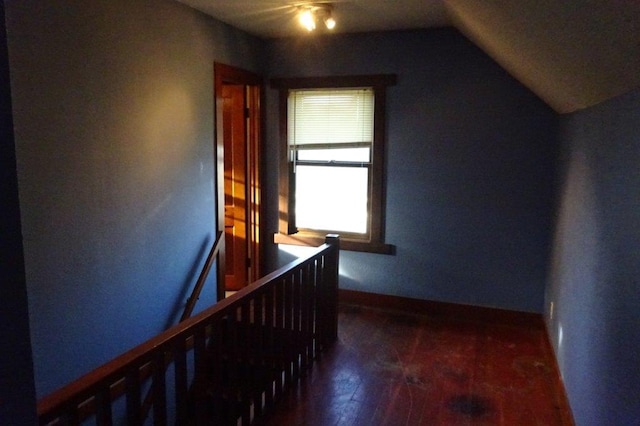 hall featuring lofted ceiling and dark hardwood / wood-style floors