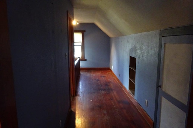 additional living space featuring lofted ceiling and dark hardwood / wood-style floors