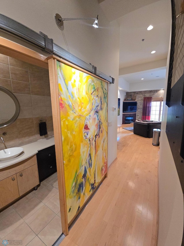 12 Broadway N Unit 206, Fargo, ND 58102 - hallway with a sink, recessed lighting, and light wood-style floors