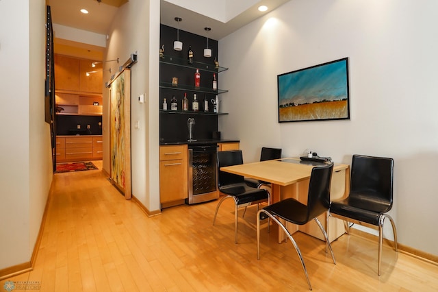 12 Broadway N Unit 206, Fargo, ND 58102 - dining room featuring beverage cooler, bar with sink, light wood-type flooring, baseboards, and recessed lighting