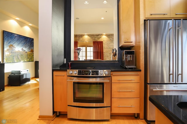 12 Broadway N Unit 206, Fargo, ND 58102 - kitchen featuring appliances with stainless steel finishes, light wood-style flooring, dark countertops, and recessed lighting