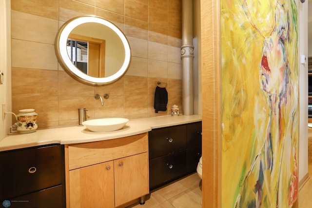 12 Broadway N Unit 206, Fargo, ND 58102 - bathroom featuring vanity, tasteful backsplash, toilet, tile walls, and tile patterned floors