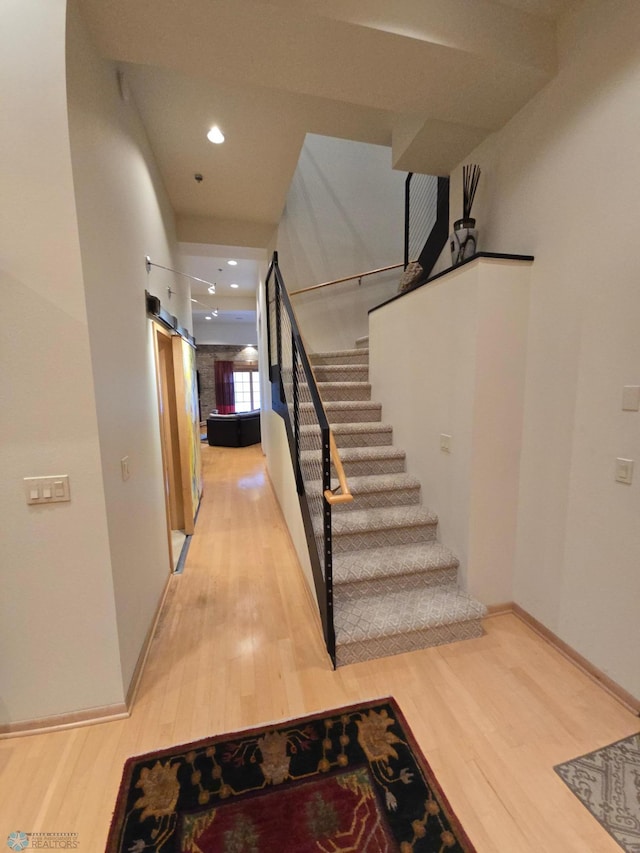 12 Broadway N Unit 206, Fargo, ND 58102 - stairs featuring wood finished floors, baseboards, and recessed lighting
