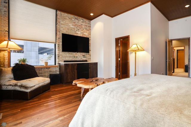 12 Broadway N Unit 206, Fargo, ND 58102 - bedroom with wood finished floors, recessed lighting, a fireplace, and a high ceiling