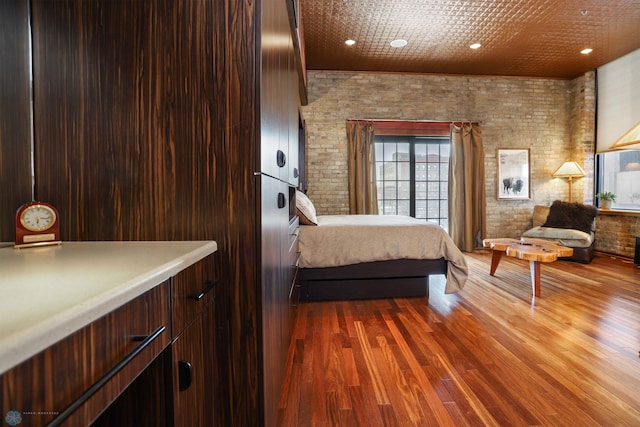 12 Broadway N Unit 206, Fargo, ND 58102 - bedroom with brick wall, dark wood finished floors, and recessed lighting