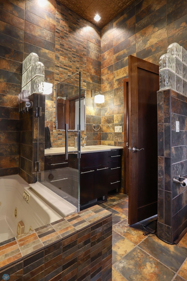 12 Broadway N Unit 206, Fargo, ND 58102 - bathroom with a jetted tub, vanity, tile walls, recessed lighting, and stone tile flooring