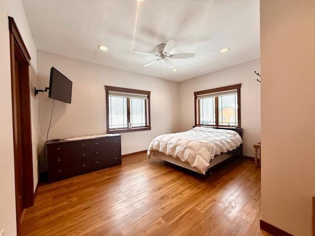 bedroom with hardwood / wood-style floors and ceiling fan