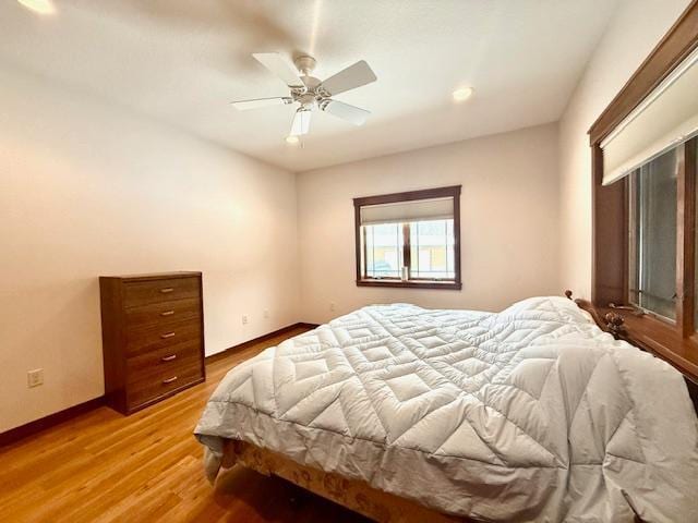 bedroom featuring ceiling fan and light hardwood / wood-style flooring