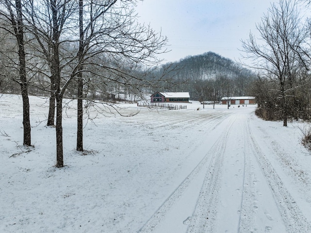 snowy yard with a mountain view