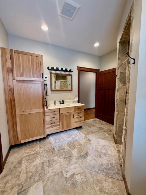 E2614 Bohland Hollow Rd, Wheatland Twp, WI 54624 - full bath featuring vanity, baseboards, and recessed lighting