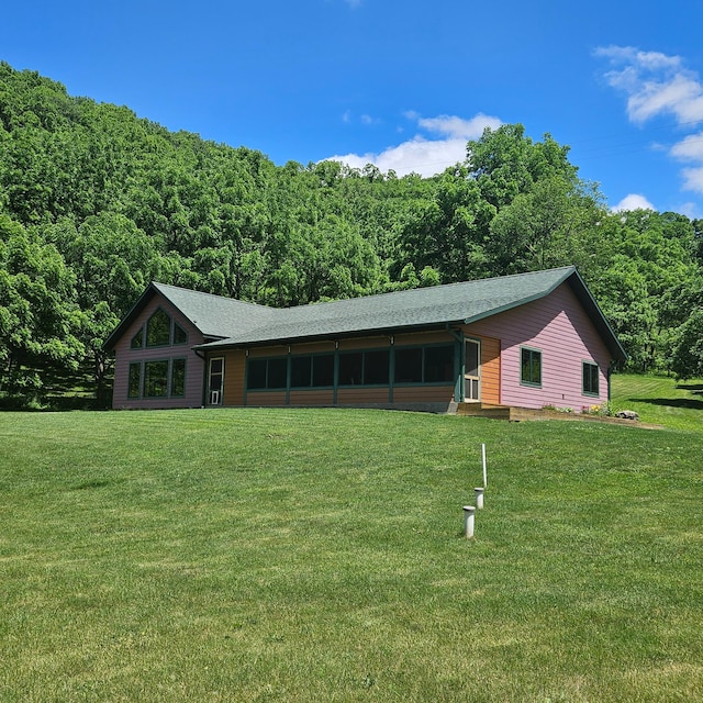 E2614 Bohland Hollow Rd, Wheatland Twp, WI 54624 - view of front facade featuring a front lawn and a wooded view