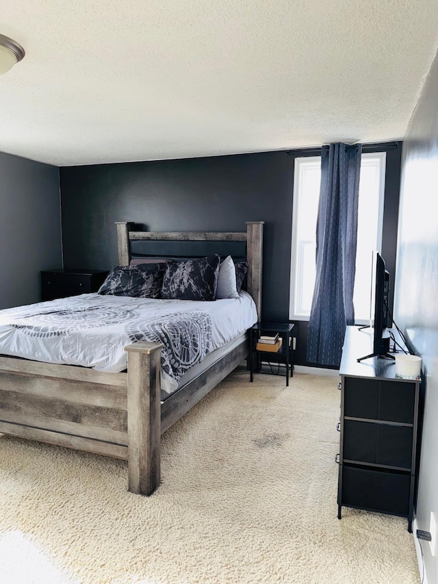 carpeted bedroom with a textured ceiling