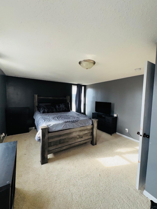 bedroom with light carpet and a textured ceiling