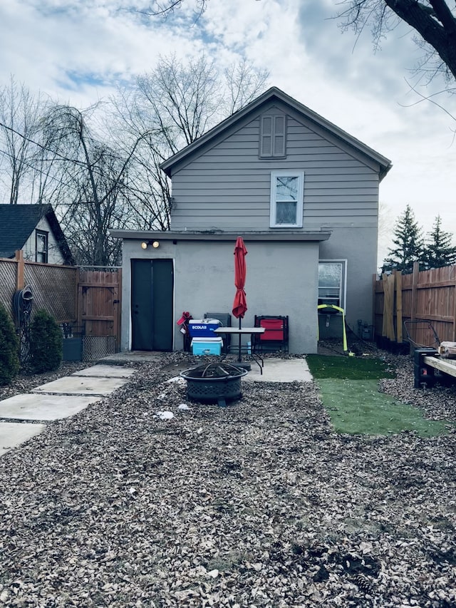 rear view of house with a fire pit