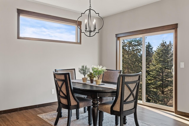 dining space featuring an inviting chandelier and hardwood / wood-style flooring