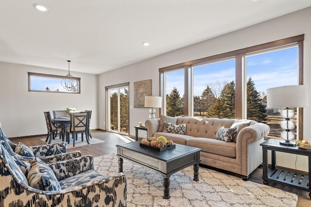 living room featuring a notable chandelier and hardwood / wood-style flooring