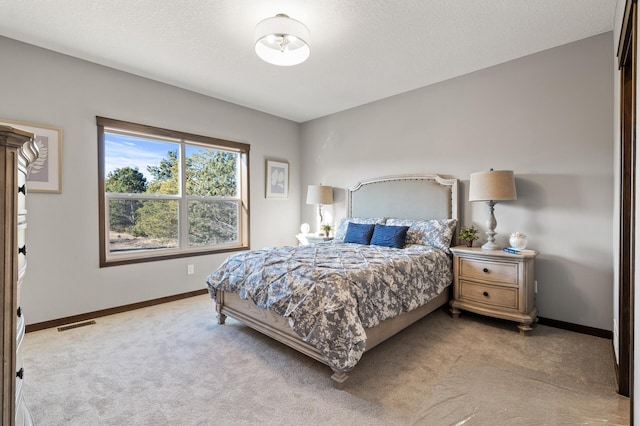 carpeted bedroom with a textured ceiling