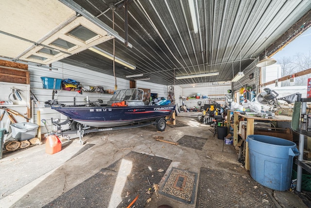 garage with a workshop area and metal wall