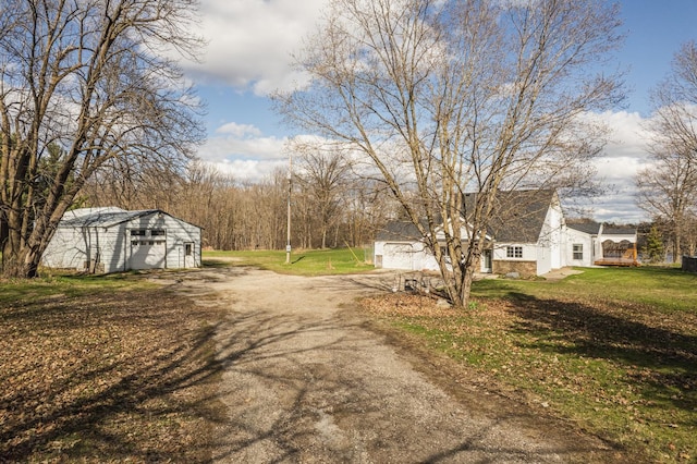 view of street with dirt driveway