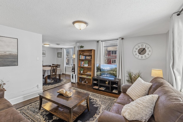 living room featuring dark hardwood / wood-style floors and a textured ceiling