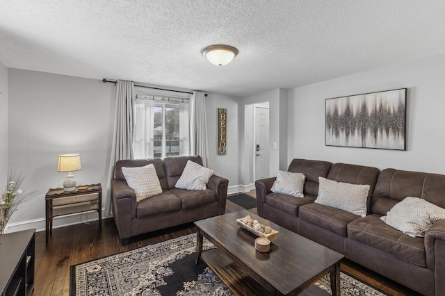 living room with dark wood-type flooring and a textured ceiling