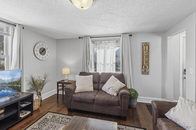 living room featuring a textured ceiling and dark hardwood / wood-style flooring