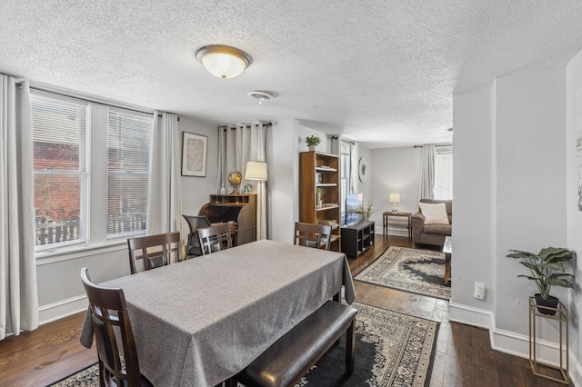 dining room with dark hardwood / wood-style flooring and a textured ceiling