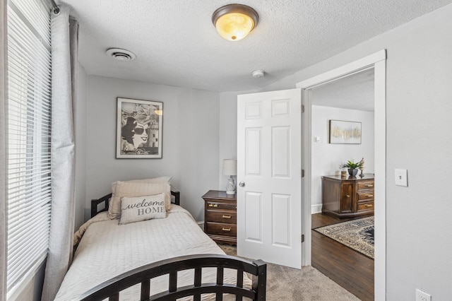 carpeted bedroom with a textured ceiling