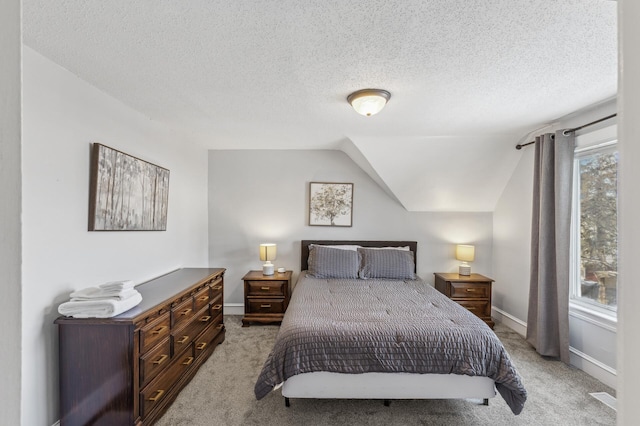 carpeted bedroom with lofted ceiling, multiple windows, and a textured ceiling