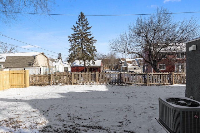 yard covered in snow with central air condition unit