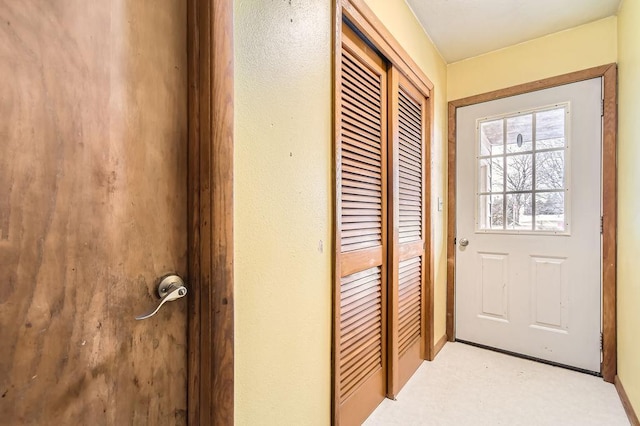 doorway to outside featuring carpet floors