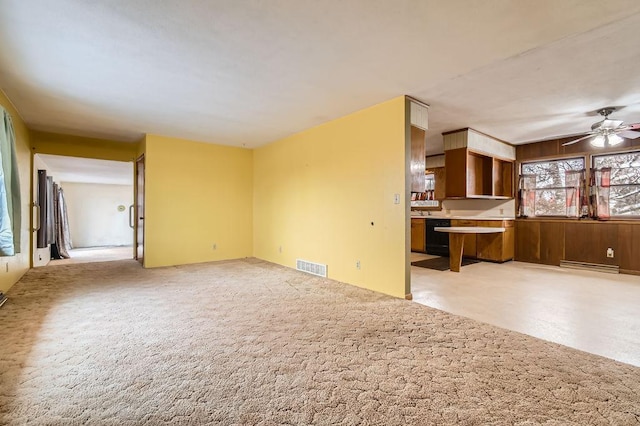 unfurnished living room featuring light carpet, visible vents, and ceiling fan