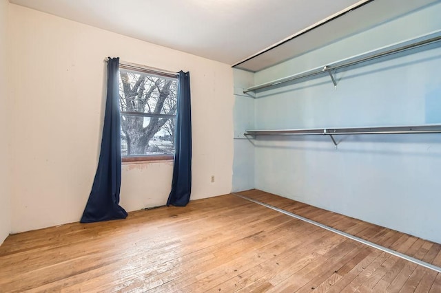 unfurnished bedroom with wood-type flooring