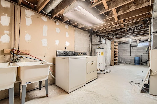 unfinished below grade area featuring water heater and independent washer and dryer