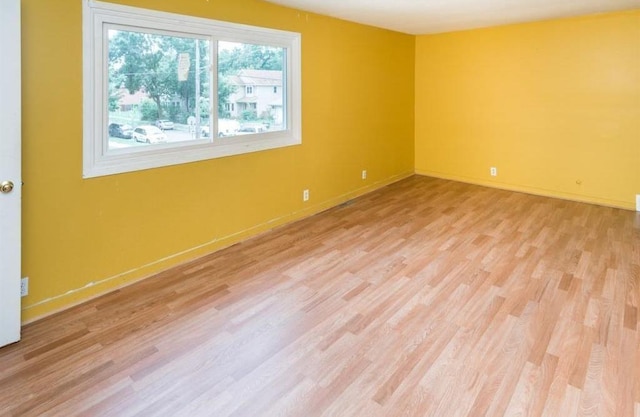 spare room with light hardwood / wood-style flooring