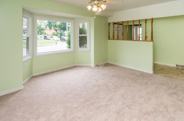 carpeted empty room with ceiling fan