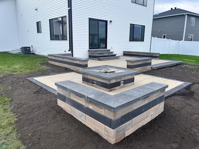 back of property featuring central AC, a patio, and a fire pit