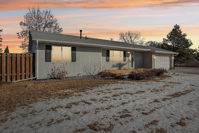 single story home featuring concrete driveway, brick siding, an attached garage, and fence