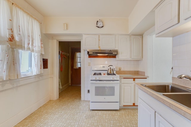 1802 3rd Ave N, Minneapolis, MN 55405 - kitchen with white cabinetry, white gas range, tasteful backsplash, and sink