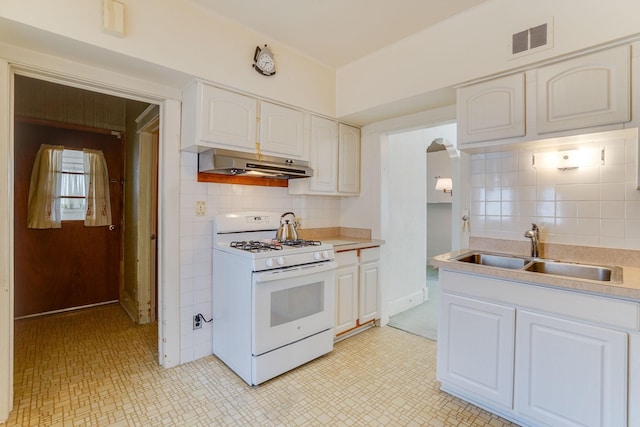 1802 3rd Ave N, Minneapolis, MN 55405 - kitchen featuring white cabinetry, sink, decorative backsplash, and white gas range oven