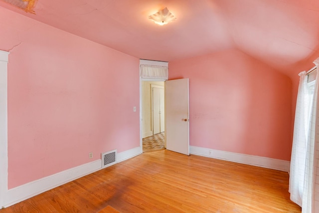 1802 3rd Ave N, Minneapolis, MN 55405 - unfurnished room with lofted ceiling and light hardwood / wood-style flooring