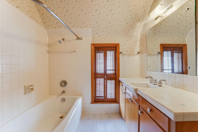 1802 3rd Ave N, Minneapolis, MN 55405 - bathroom featuring tile patterned flooring, tiled shower / bath, tile walls, and vanity