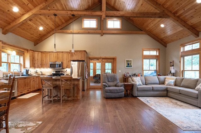 living room with sink, hardwood / wood-style floors, wood ceiling, and beam ceiling